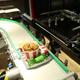 A KFC in Moscow sends chicken along a conveyor belt to be delivered by a robotic arm.